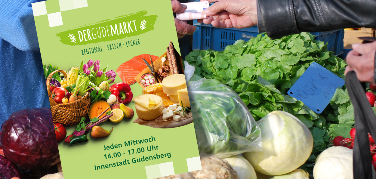 Martkstand mit Käufer und Verkäufer mit Gudemarktflyer im Vordergrund